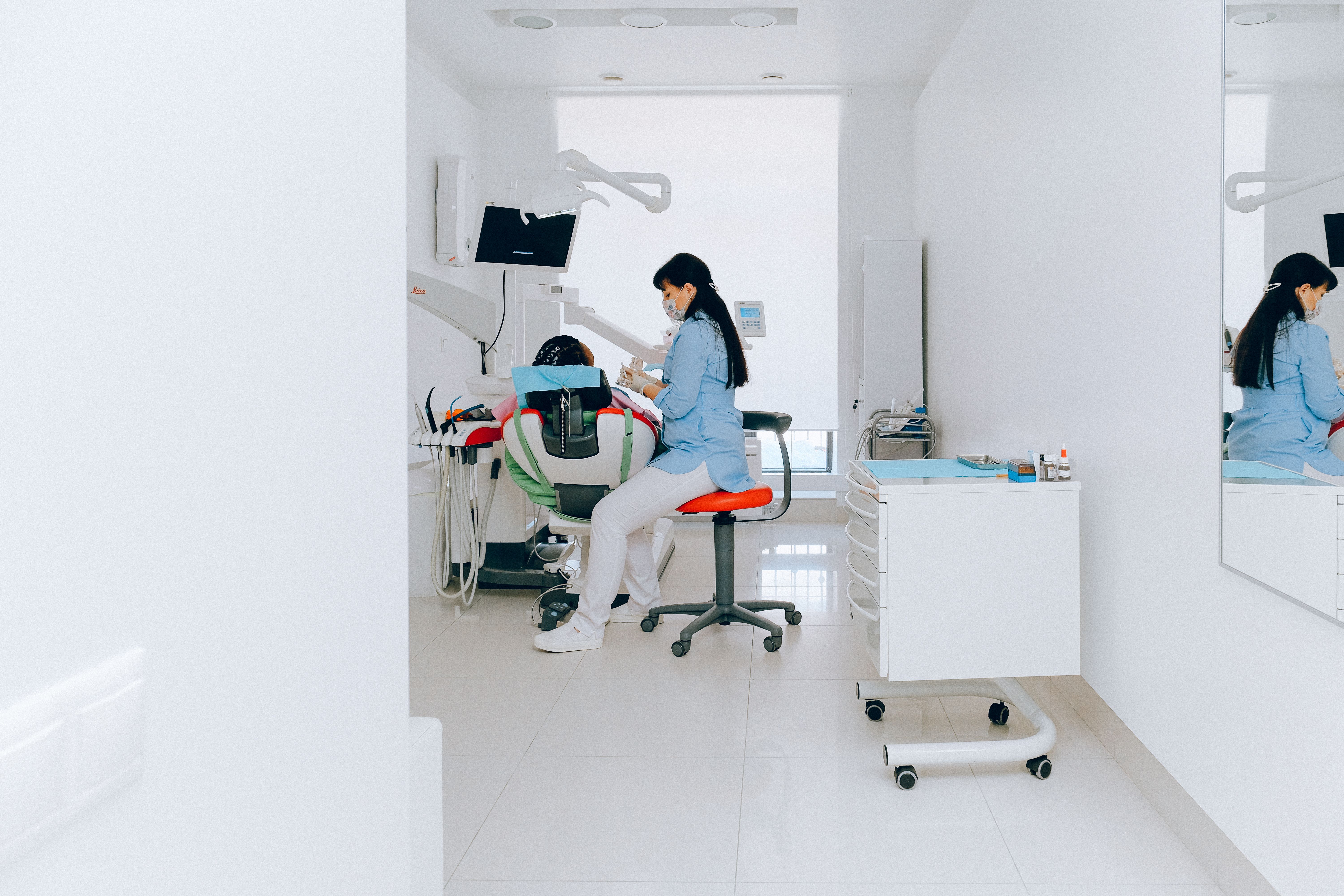 Professional dentist providing gentle dental care to a patient in a modern dental office